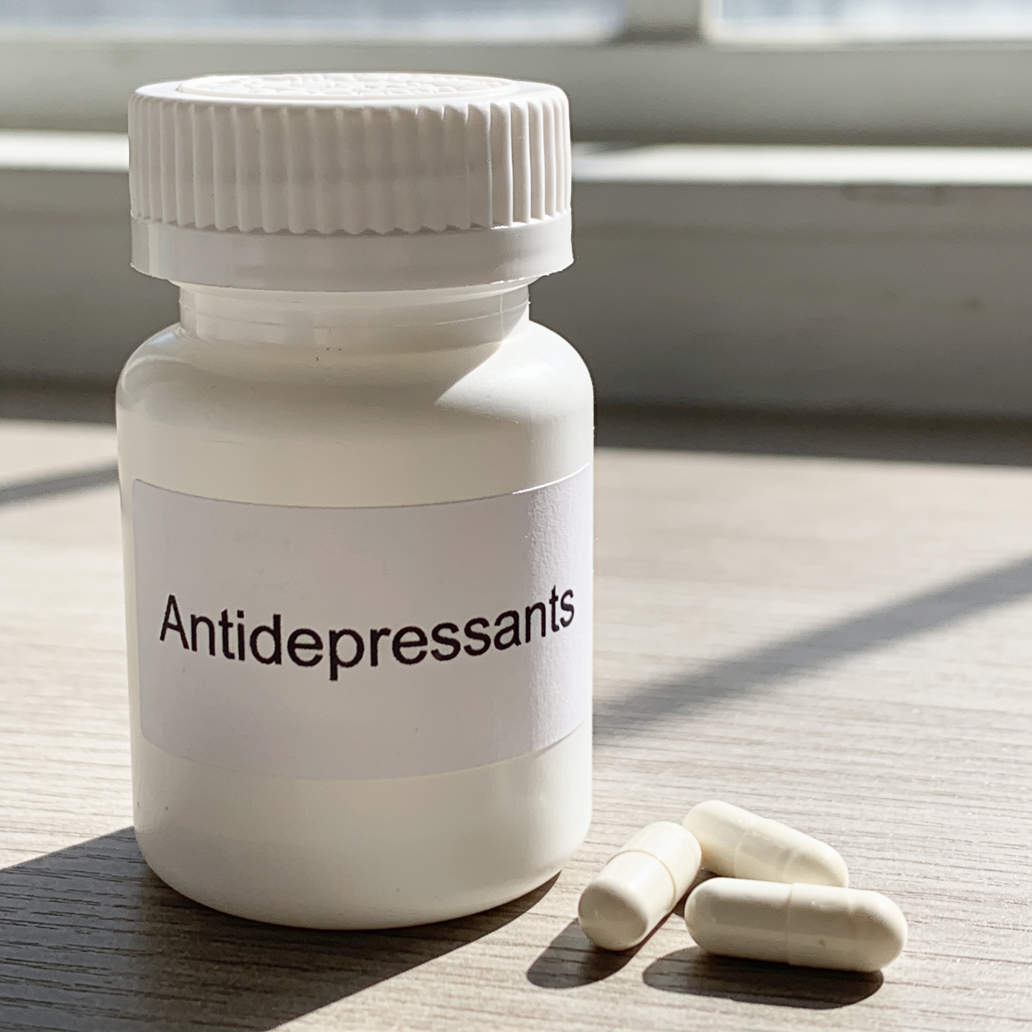 A white pill bottle labeled 'Antidepressants' is selected in a website media library as the focus keyphrase for the post.»